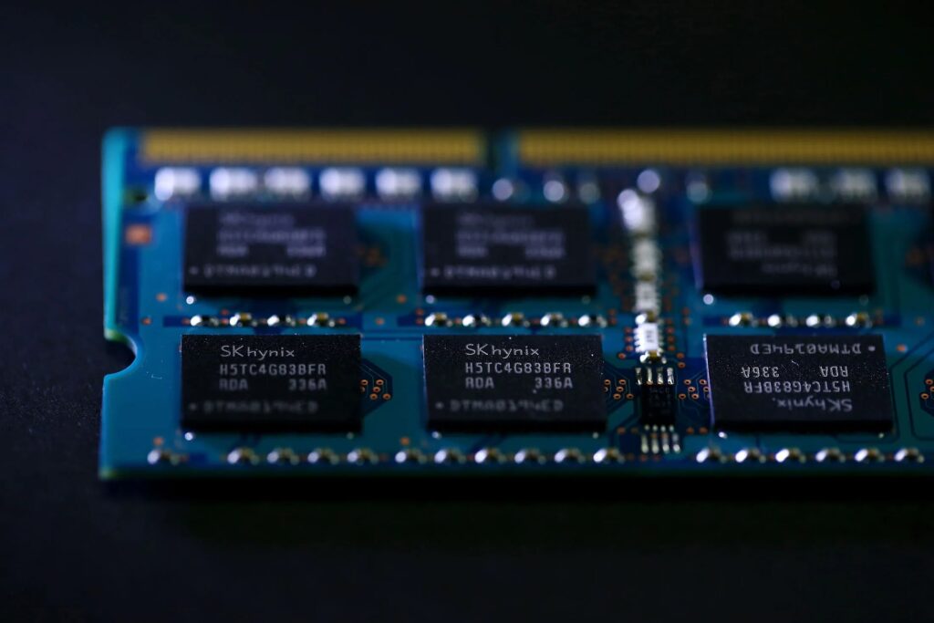 A close-up shot of an sk hynix chipmaking product, specifically a blue circuit board featuring multiple black memory chips with the sk hynix logo
