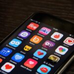 A smartphone screen displaying a grid of various dating apps including Tinder, Bumble, Badoo, and Zoosk, representing the shift toward using these platforms for a modern job search